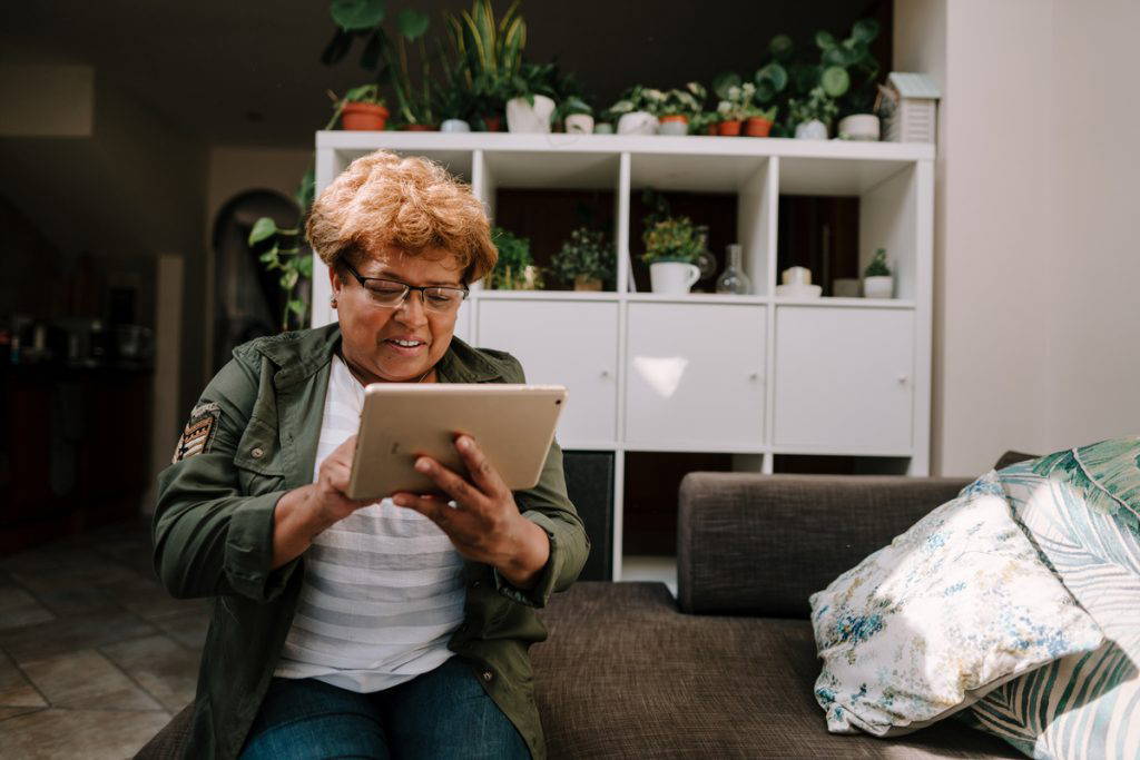 woamn looking at a tablet in a home