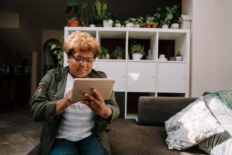 woamn looking at a tablet in a home